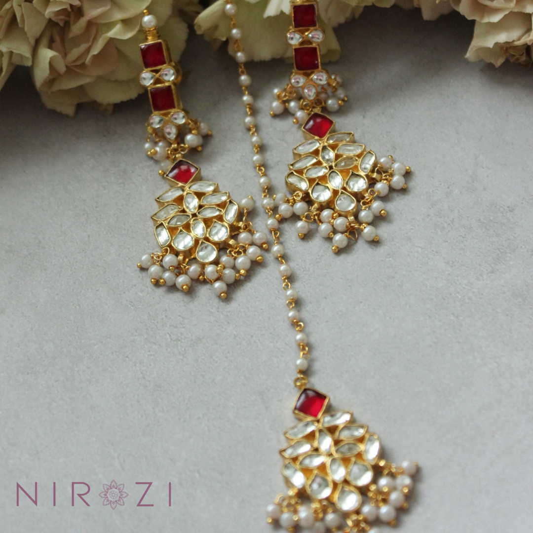 Earring and tikka set is brass based with stones set in silver foil and 18kt gold plated. The perfect piece to add to your collection of Kundan jewelry. Beautifully handcrafted and made to last you a lifetime. Beautiful Ruby color set.