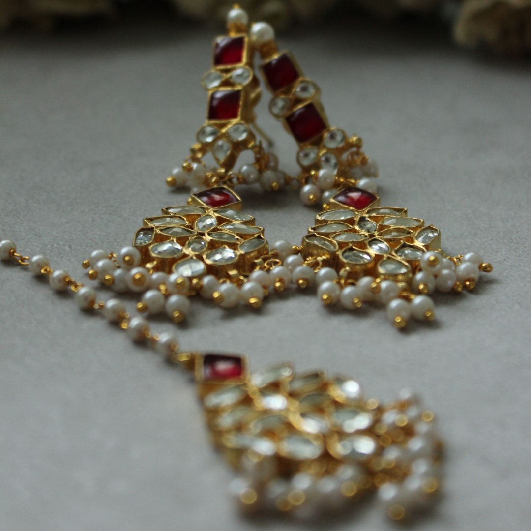Earring and tikka set is brass based with stones set in silver foil and 18kt gold plated. The perfect piece to add to your collection of Kundan jewelry. Beautifully handcrafted and made to last you a lifetime. Beautiful Ruby color set. High quality desi jewelry.